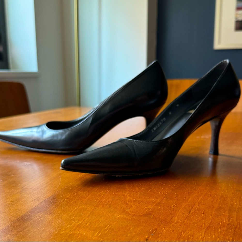 Stuart Weitzman black high heel pumps.